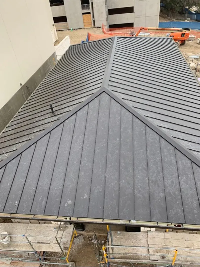 Commercial metal roof construction with crane equipment in Steelton